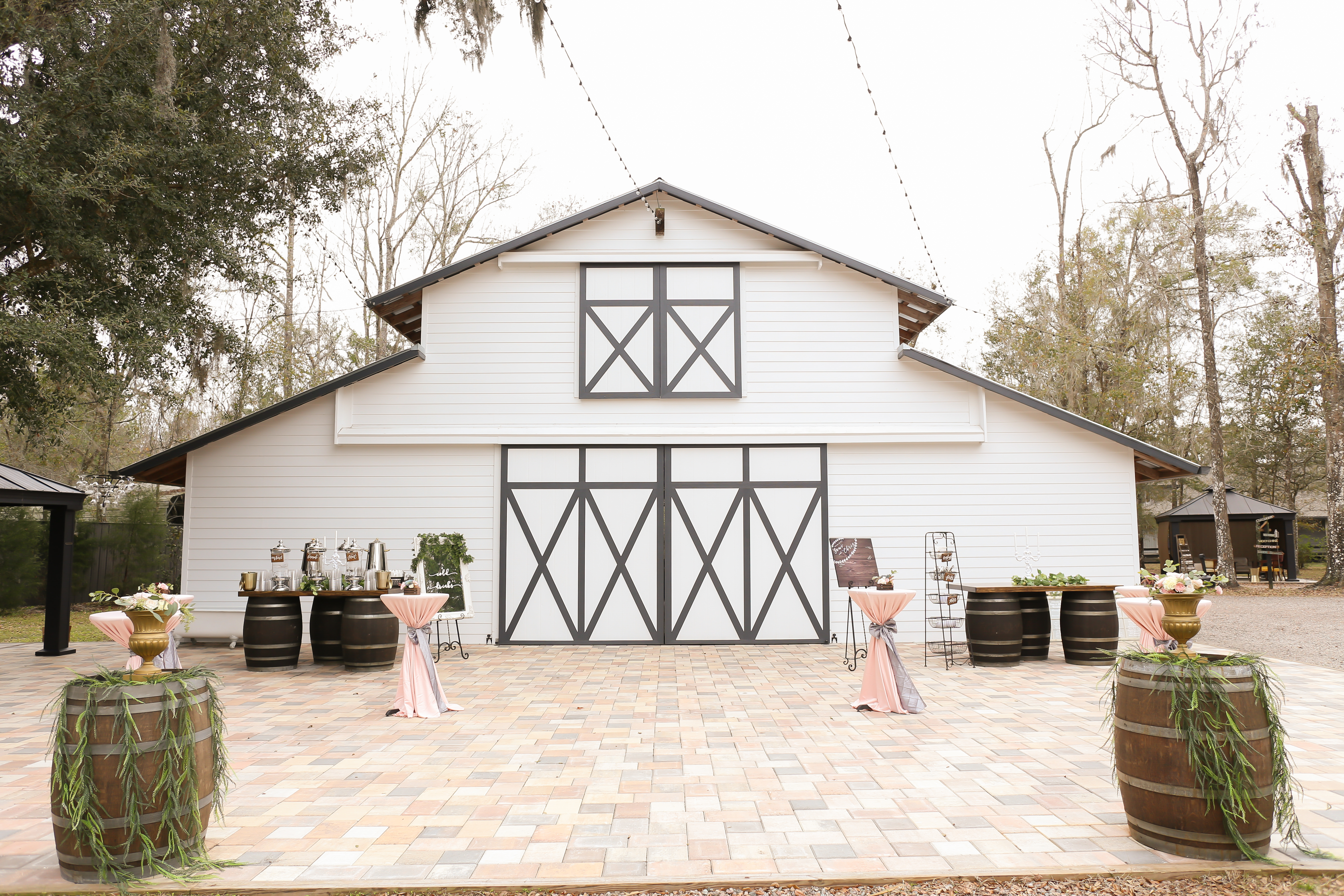 Rustic Wedding Ceremony Decor, Wooden Barrels with Greenery, Gold Vases and Florals, Cocktail Tables with Blush Pink Linens | Tampa Bay Wedding Photographer Lifelong Photography Studios | Rustic Florida Wedding Venue The White Barn