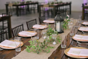 Tampa Bay Wedding Reception Decor, Long Wooden Table, Burlap Table Runner, Greenery Garland, Black Lantern Centerpiece, Gold Charger and Blush Pink Linens