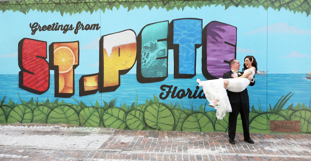 Florida Bride and Groom Wedding Portrait in Front of St Pete Decorated Wall | lTampa Bay Wedding Photographer Lifelong Photography Studio