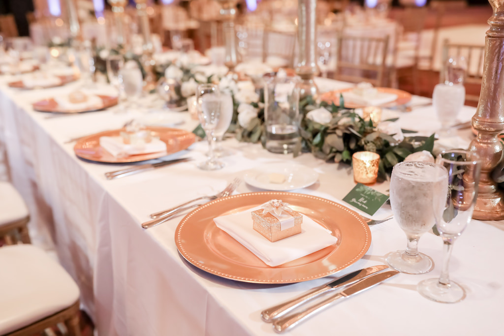 Wedding Reception Decor, Long Feasting Table with White Tablecloth, Gold Chargers with Gold Box Wedding Favor, Greenery Garland | Tampa Bay Wedding Photographer Lifelong Photography Studio