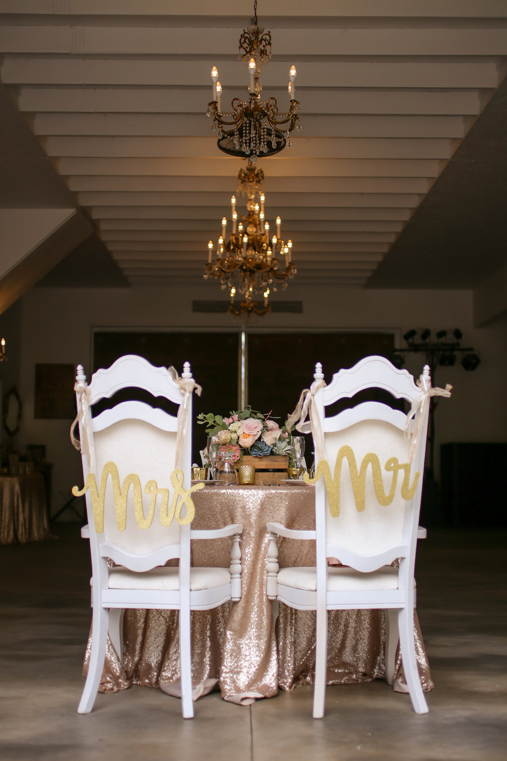 Rustic Wedding Reception Decor, Sweetheart Table with Glitter Rose Gold Linen, Vintage Chairs with Custom Gold Laser Cut Mr and Mrs Signs | Tampa Bay Wedding Photographer Lifelong Photography Studios | Florida Rustic WEdding Venue The White Barn