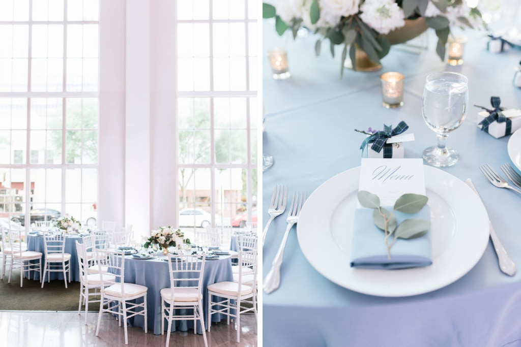 Elegant, Classic White and Dusty Blue Wedding Reception Decor with Round Tables, Dusty Blue Tablecloths, White Chiavari Chairs and Low White Roses, Hydrangeas and Greenery Floral Centerpieces, Dusty Blue Linen with Silver Dollar Eucalyptus and Menu | Downtown Tampa Wedding Venue The Vault