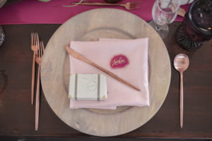 Travel Inspired Wedding Reception Decor, Wooden Charger with Blush Pink Linen, Rose Gold Silverware, Agate Slice Quartz Place Card and Suitcase Wedding Favor Box | Tampa Bay Wedding Photographer Lifelong Photography Studios