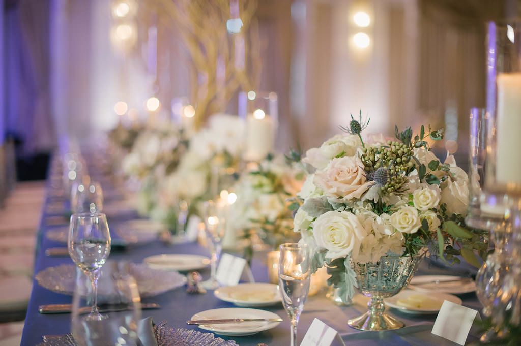 Elegant white wedding reception low centerpieces with greenery