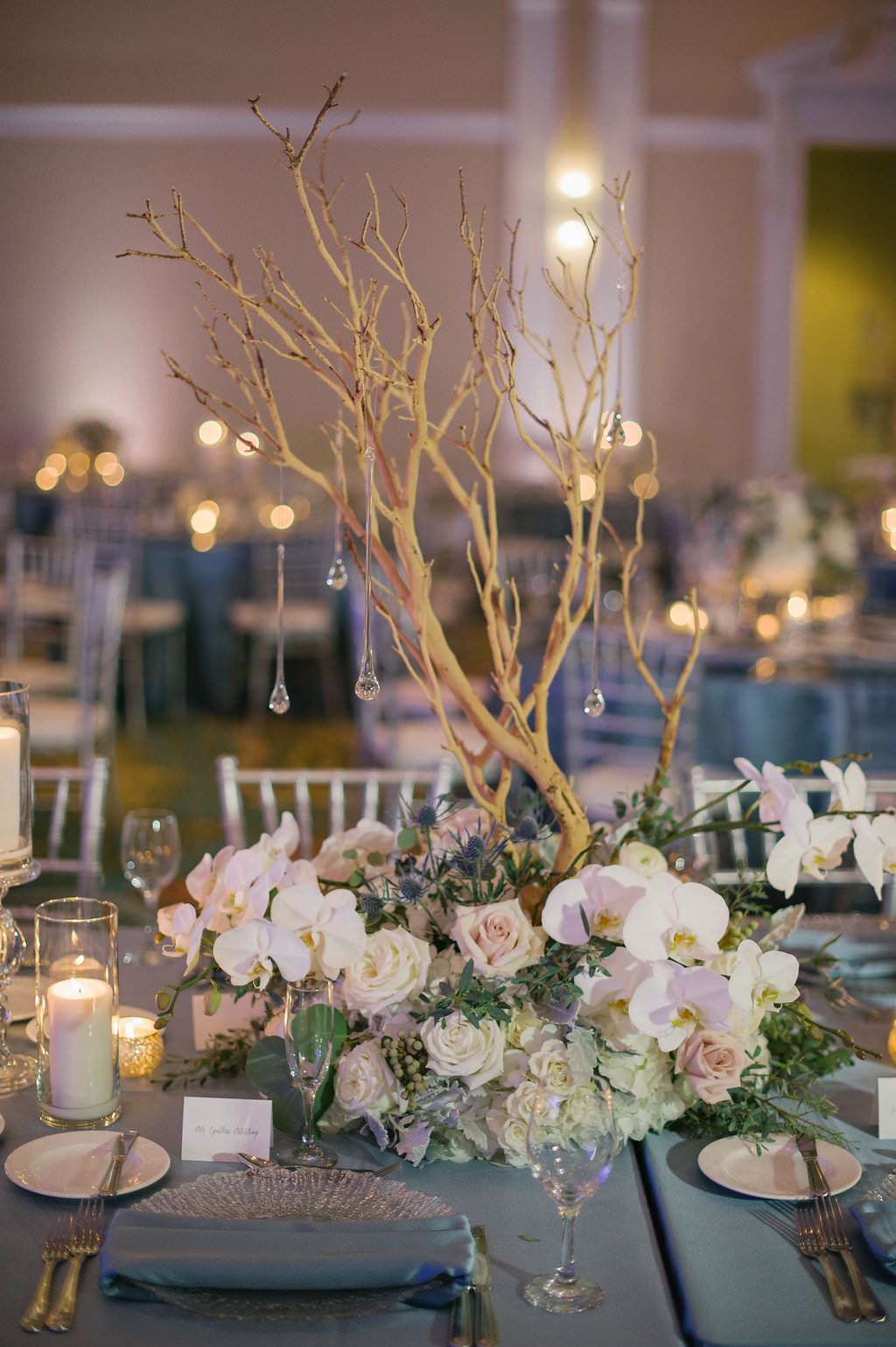 Blue, blush, and white wedding centerpiece with manzanita branches