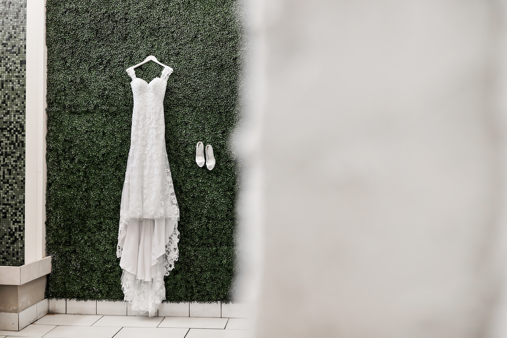 Fitted Lace Sweetheart Neckline with Thick Lace Straps Hanging on Greenery Wall | Tampa Bay Wedding Photographer Lifelong Photography Studios | Downtown St. Pete Wedding Venue The Birchwood
