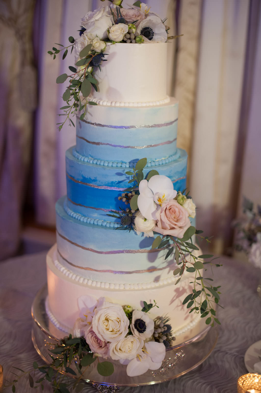 Watercolor blue and white 5-tier wedding cake with flowers