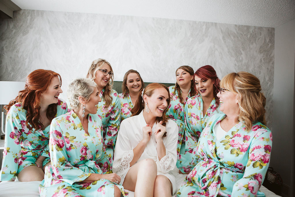 Bridesmaids getting ready with bride in matching floral print robes | Tampa Bay Hair and Makeup Artist Michele Renee The Studio
