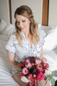Florida Bride Getting Ready Wedding Portrait in Silk Floral and Light Blue Robe with Jewel Tone, Purple, Plum, Pink, White and Greenery Organic Floral Bouquet | Tampa Bay Wedding Photographer Lifelong Photography Studios | Hair and Makeup Artist Femme Akoi