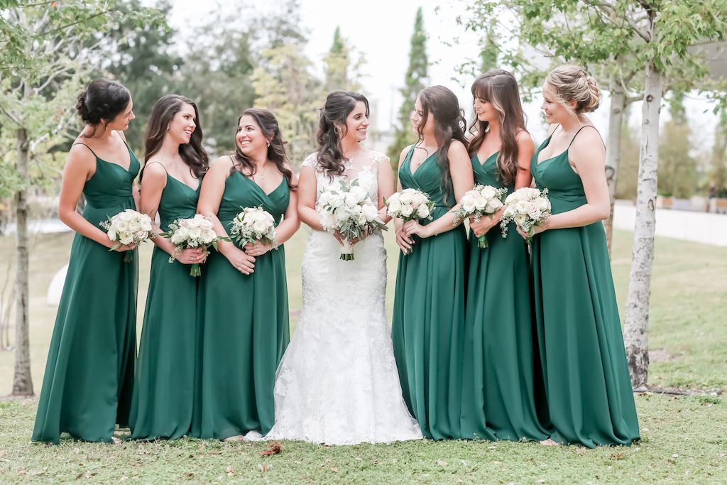 Florida Bride and Bridesmaids Outdoor Wedding Portrait, Bridesmaids in Emerald Green Matching Strappy Long Dresses, Bride in Lace and Illusion Fit and Flare Wedding Dress with Ivory, White and Greenery Floral Bouquets | Tampa Bay Wedding Photographer Lifelong Photography Studio | Hair and Makeup Artist Femme Akoi