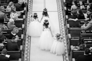 Flower Girls Walking Down the Aisle During Wedding Ceremony in White Tulle Dresses with Bows | Tampa Wedding Venue Sacred Heart Catholic Church