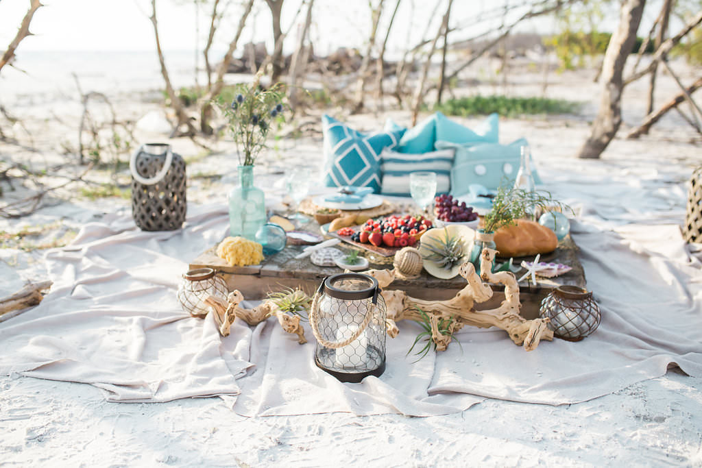 Florida Beach Wedding Style Shoot, Wooden Plank with Fruit Platter, Blue Vases, Blue Pillows, Nautical Lanterns, Birchwood, Seashells | Tampa Bay Wedding Planner UNIQUE Weddings and Events | Tampa Wedding Venue Fort DeSoto Park | Rentals Over the Top Linen Rentals