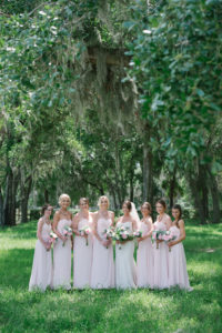 Florida Bride and Bridesmaids Outdoor Wedding Portrait, Bridesmaids in Blush Pink Long Matching Dresses, Bride in Lace Strapless Sweetheart Fitted Wedding Dress | Inverness Rustic Wedding Venue Lakeside Ranch