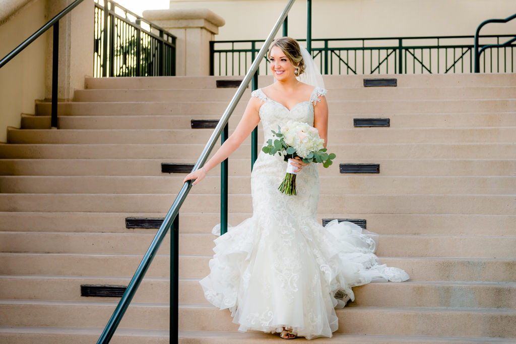 Florida Bride Wedding Portrait, Bride in Cap Sleeve Sweetheart Lace Fitted Ruffled Skirt Wedding Dress with White and Greenery Floral Bouquet