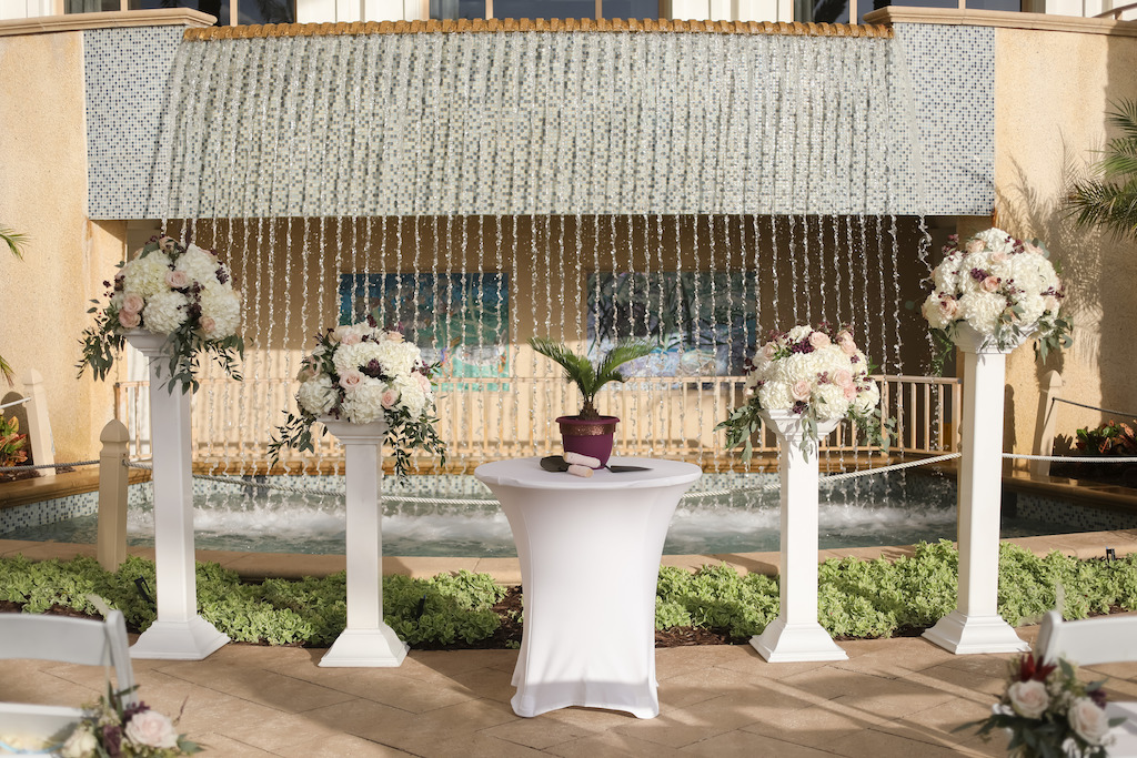 Outdoor Lawn Ceremony Decor, Unity Table with Plant, Tall White Pedestals with Ivory, Blush Pink, Greenery Floral Bouquets | Tampa Bay Wedding Photographer Lifelong Photography Studios | Clearwater Beach Wedding Hotel Venue Sandpearl Resort | Wedding Planner Special Moments Event Planning