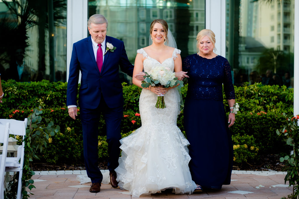 Florida Bride and Parents Walking Down the Aisle Wedding Ceremony Portrait, Bride in Cap Sleeve Sweetheart Lace Fitted Ruffled Skirt Wedding Dress with White and Greenery Floral Bouquet