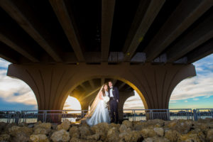 St. Petersburg Waterfront Bride and Groom Under Bridge Sunset Wedding Portrait