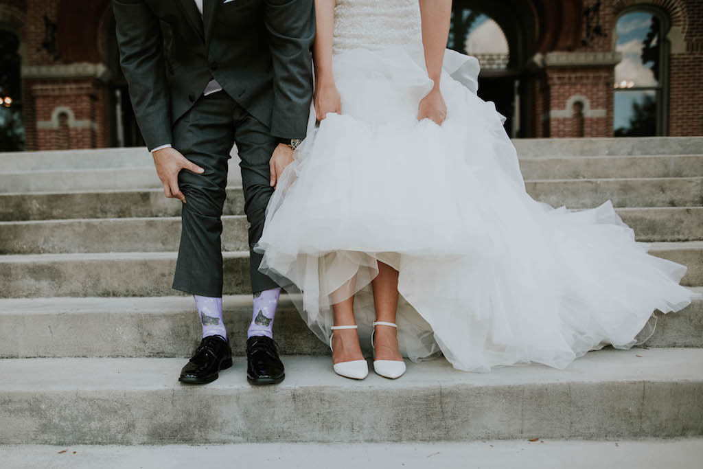 University of Tampa Bride and Groom Portrait, Bride in Pointed Toe Strappy White Wedding Shoes, Groom with Purple Cat Socks and Black Wingtip Dress Shoes