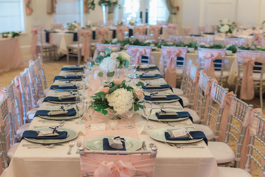 Elegant Wedding Reception Decor, Long Table with Silver Chiavari Chairs and Blush Pink Sashes, Silver Chargers and Navy Blue Lines, Low White Hydrangeas, Blush Pink Roses and Greenery Flower Centerpieces, Blush Pink Table Runner | Brooksville Golf Course Wedding Venue Southern Hills Plantation Club