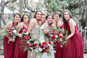 Bride and Bridesmaids Outdoor Wedding Portrait, Bridesmaids in Mismatched Style Red Long Dresses, Maid of Honor in Rhinestone and Champagne Dress Holding Tropical Orange, Red, Purple, Pink, White, Silver Dollar Eucalyptus and Greenery Floral Bouquets | Tampa Bay Wedding Photographer Lifelong Photography Studio | Hair and Makeup Michele Renee the Studio