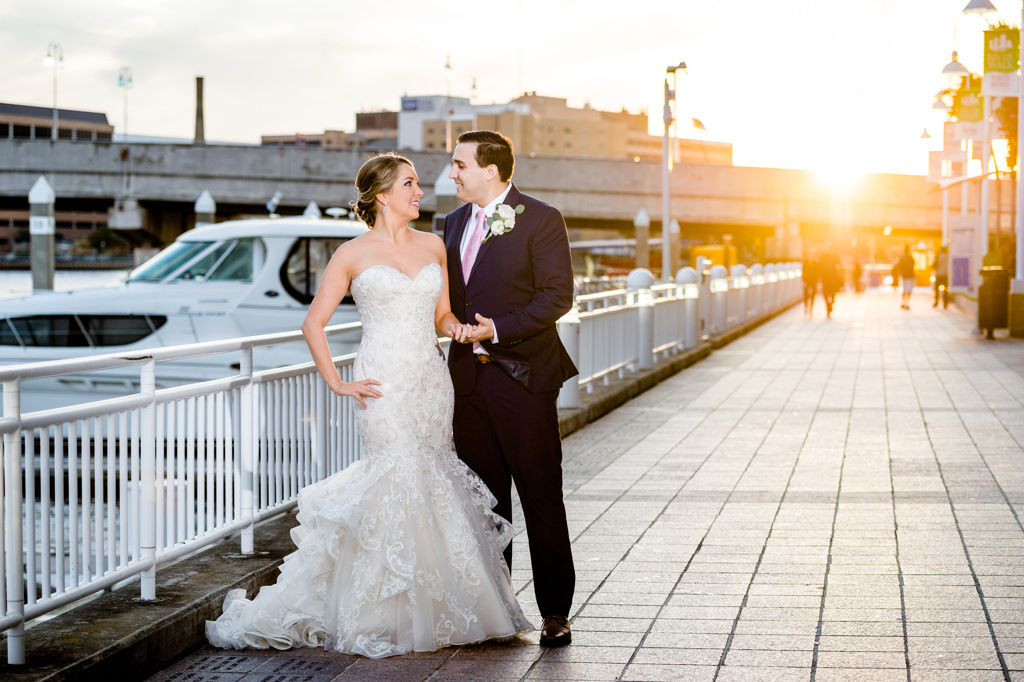 Florida Bride and Groom Wedding Portrait on Tampa Boardwalk, Bride in Strapless Sweetheart Lace Fitted and Ruffle Skirt Wedding Dress | Downtown Tampa Wedding Venue Tampa Marriott Water Street