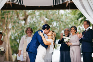 Florida Garden Bride and Groom First Kiss Wedding Ceremony Portrait | Sarasota Wedding Venue Marie Selby Botanical Gardens | Tampa Bay Wedding Planner NK Productions