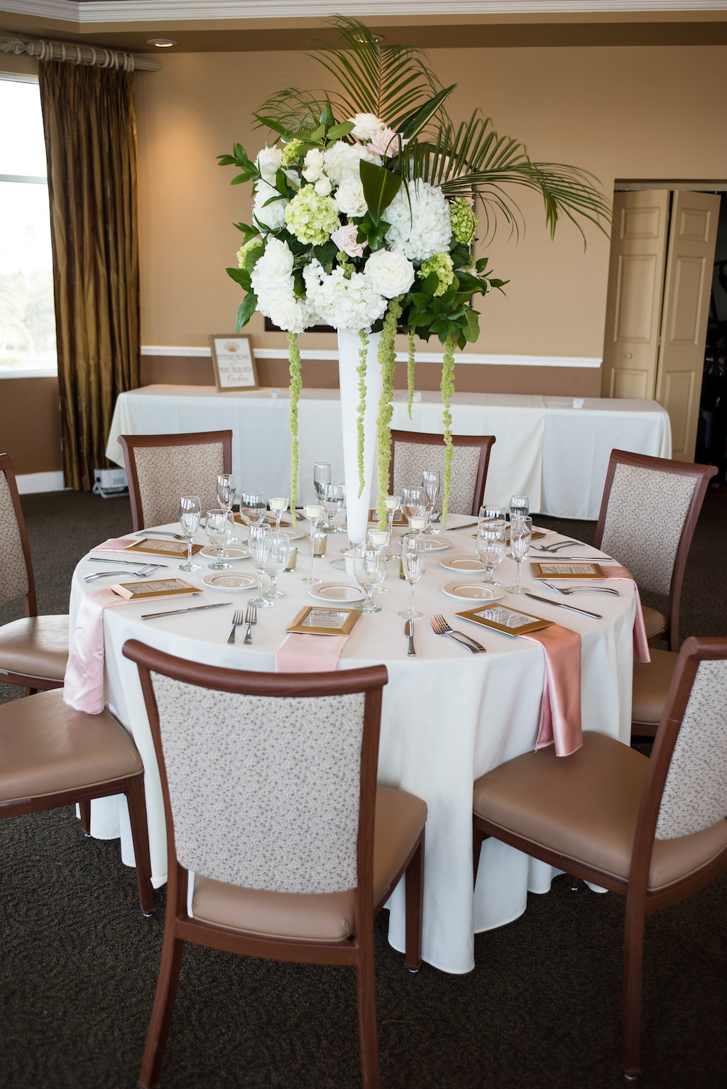 Classic Traditional Ballroom Wedding Reception Decor, Round Table with White Tablecloth, Blush Pink Linens, Tall White Vase with White, Blush Pink, Greenery, Palm Tree Branches and Green Hanging Amaranthus Floral Centerpiece | St. Petersburg Wedding Venue Isla Del Sol Yacht and Country Club
