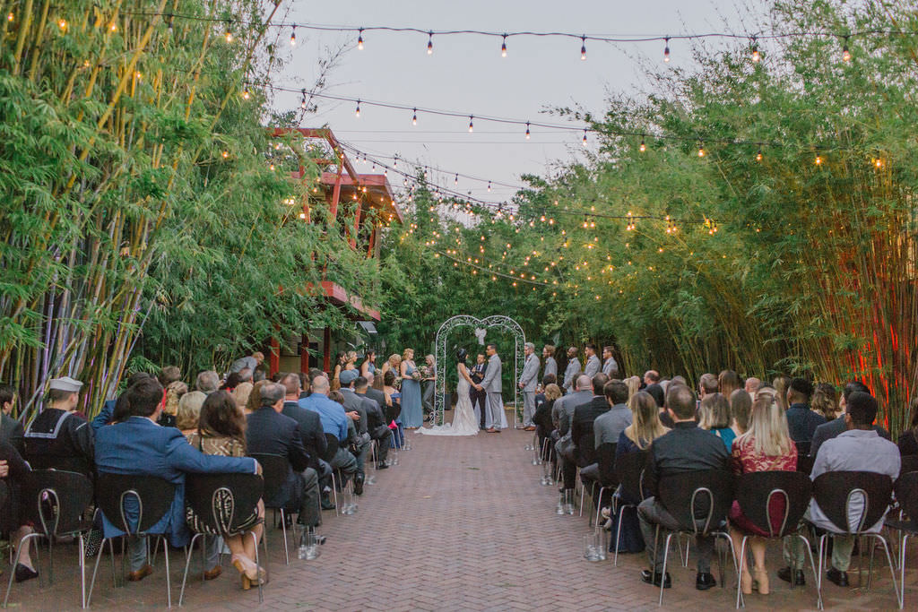 Bamboo garden ceremony under string lights in St. Pete at NOVA 535 | Tampa Bay Wedding Photographer Kera Photography