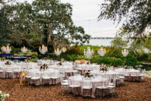Outdoor Garden Wedding Reception Decor, Round Tables, Ghost Acrylic Chiavari Chairs, Low Flower Centerpieces, Hanging Crystal Chandeliers | Sarasota Wedding Venue Marie Selby Botanical Gardens | Tampa Bay Wedding Planner NK Productions