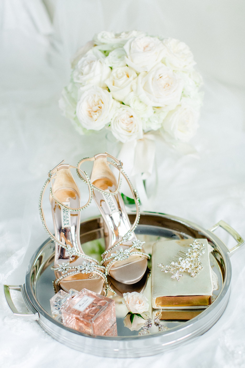 Rose Gold Strappy Rhinestone Badgley Mischka Heel Wedding Shoes, Perfume Bottle, Sage Green Leather Book, Rhinestone Headpiece on Round Mirror Tray and Ivory Rose Floral Bouquet