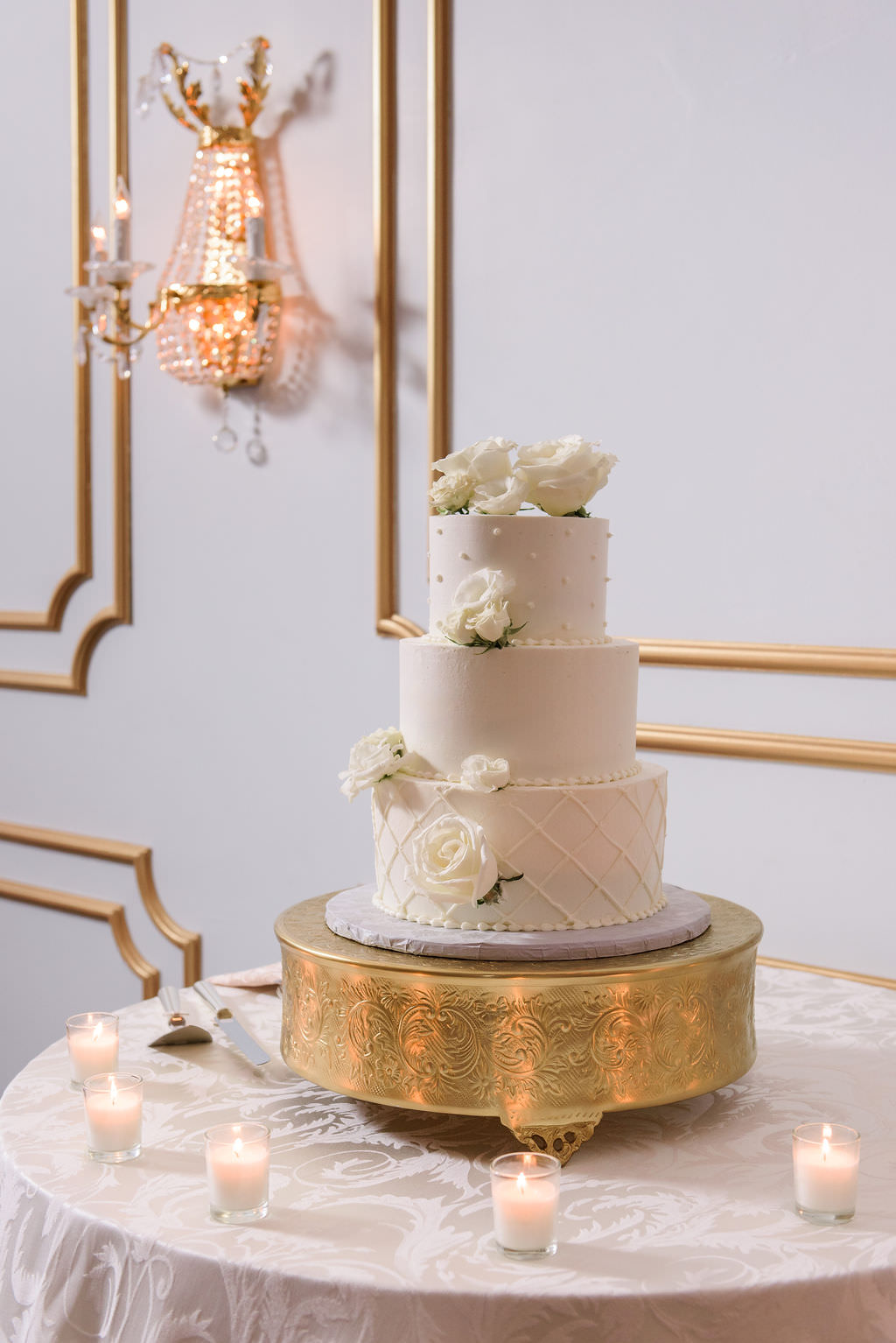 Classic Three Tier White Wedding Cake with Real White Roses on Gold Cake Stand