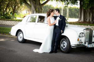 Tampa Bay Bride and Groom Outdoor Wedding Portrait in Front of White Vintage Rolls Royce Car