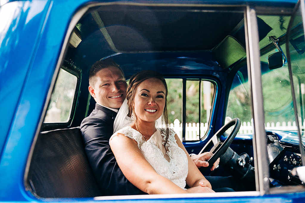 Florida Bride and Groom Wedding Portrait in Bright Blue Vintage Car