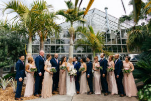 Outdoor Bride, Groom, Bridesmaids and Groomsmen Bridal Party Wedding Portrait, Bridesmaids in Mismatched Blush Dresses, Groomsmen in Navy Blue Suits | Sarasota Wedding Venue Marie Selby Botanical Gardens | Wedding Planner NK Productions