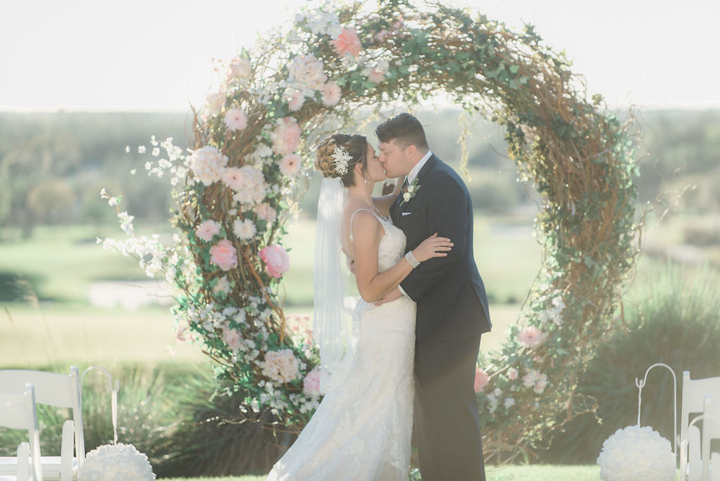 Florida Bride and Groom Wedding Ceremony Portrait, Circular Tree Branch Ceremony Arch with Blush Pink, Ivory and Greenery Flowers