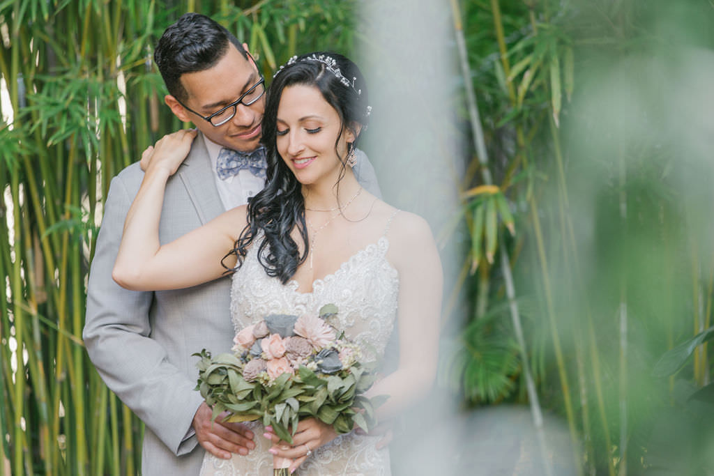 Bride in lace wedding dress with blush and gray bouquet with groom in gray suit | St. Pete wedding photographer Kera Photography | Bamboo Garden Downtown St. Pete Wedding Venue NOVA 535