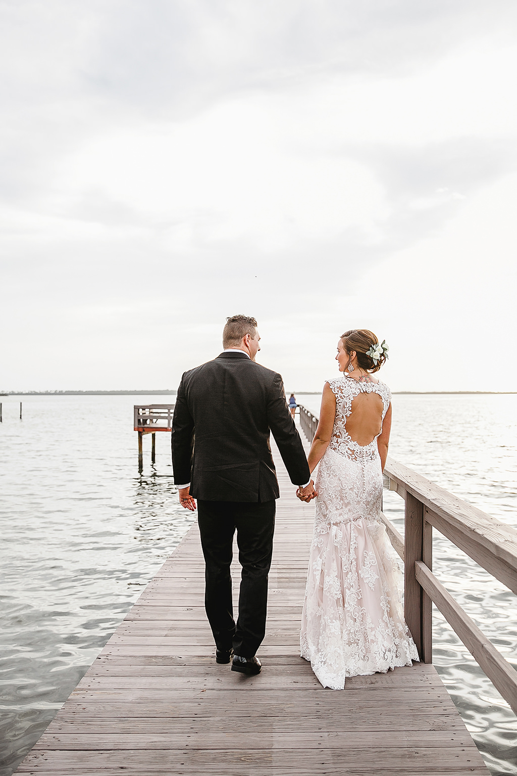 Tampa Bay Waterfront Bride and Groom Wedding Portrait Walking on Pier | Dunedin Wedding Venue Beso Del Sol