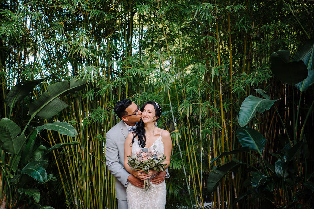 Bride in lace wedding dress with blush and gray bouquet with groom in gray suit | St. Pete wedding photographer Kera Photography | Bamboo Garden Downtown St. Pete Wedding Venue NOVA 535