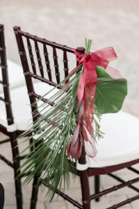 Tropical Inspired Wedding Ceremony Decor, Wooden Chiavari Chair with White Cushions, Palm Tree Leaves and Red Ribbon | Tampa Bay Wedding Photographer Lifelong Photography Studio