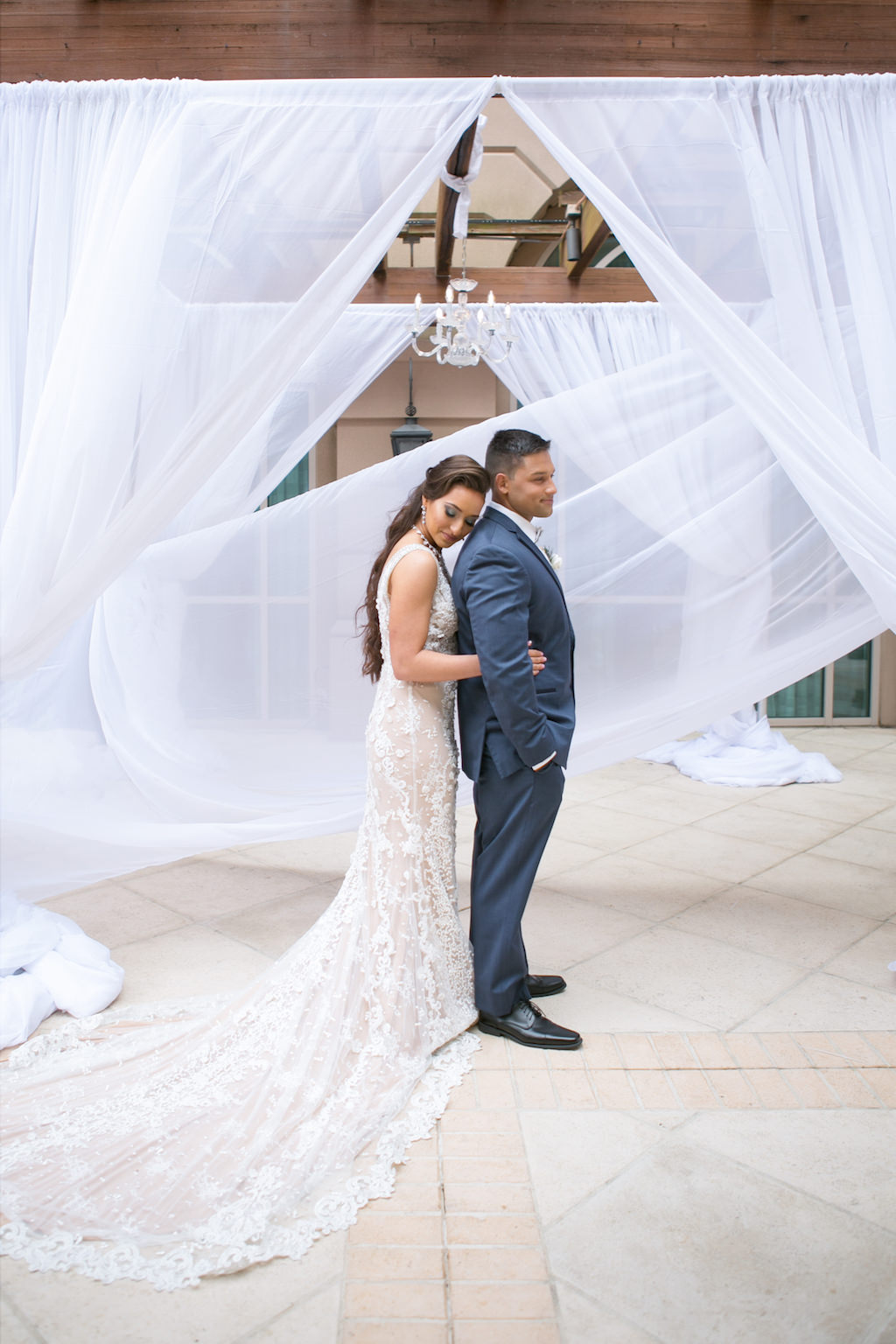 Florida Bride and Groom Wedding Portrait in Hotel Courtyard with White Linen Draping | Tampa Bay Wedding Photographer Carrie Wildes Photography | Wedding Planner Coastal Coordinating | Linens Gabro Event Services | Wedding Venue Renaissance Tampa International Plaza