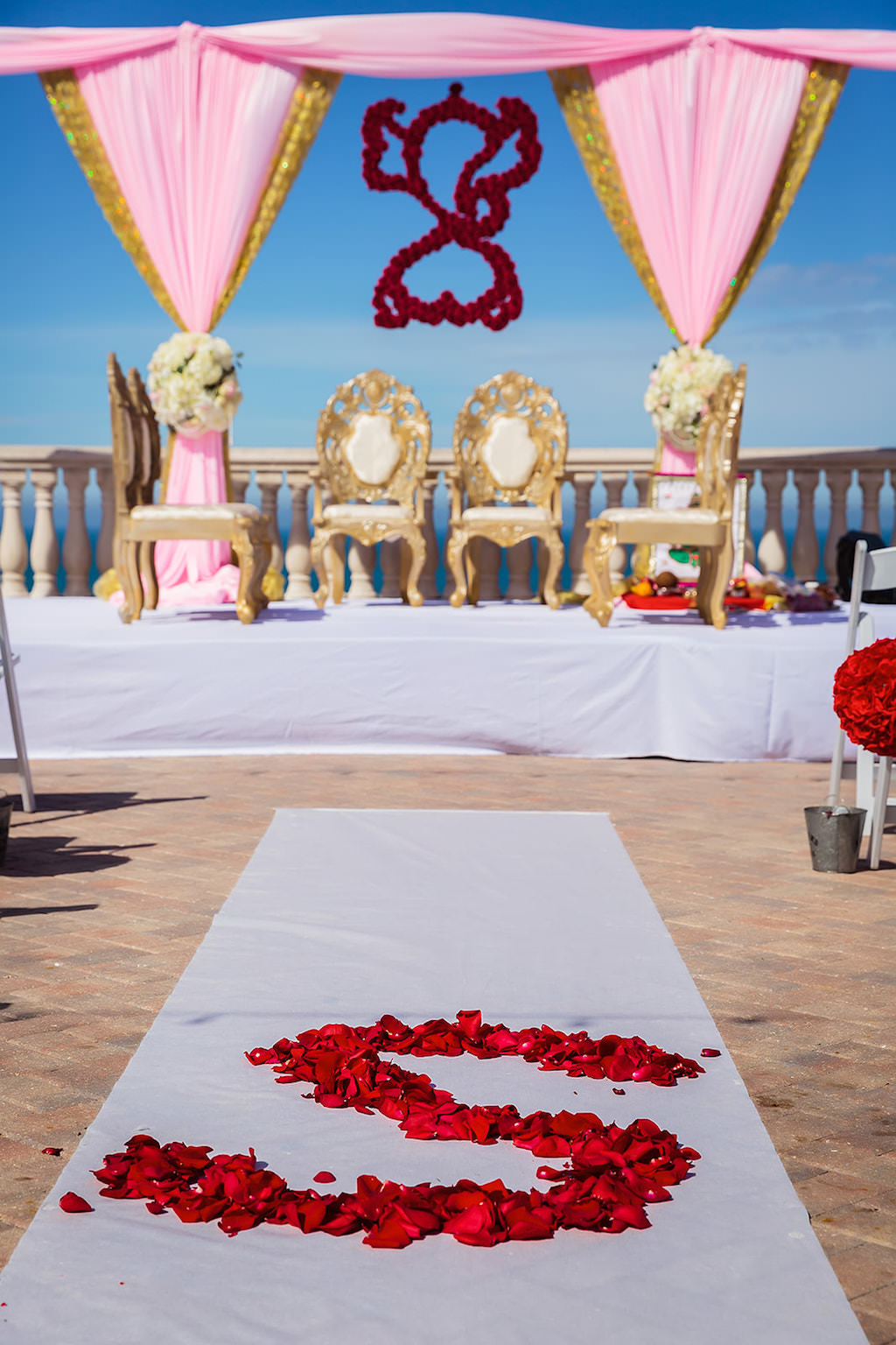Florida Indian Hindu Rooftop Wedding Ceremony Decor, Gold and Blush Pink Linen Drapery Arch, White, Ivory Blush Pink Floral Bouquets, Red Hanging Floral Decor, Gold and Ivory Cushion Chairs, White Aisle Runner with Personalized Red Rose Petal | Clearwater Beach Wedding Venue Hyatt Regency Clearwater