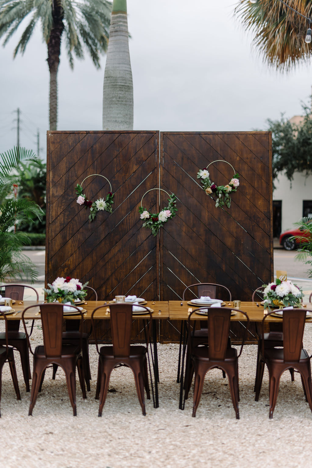 Open Air St. Pete Wedding Reception with Wooden Accent Wall and Metal Chairs | Outdoor St. Pete Wedding Reception Venue Intermezzo