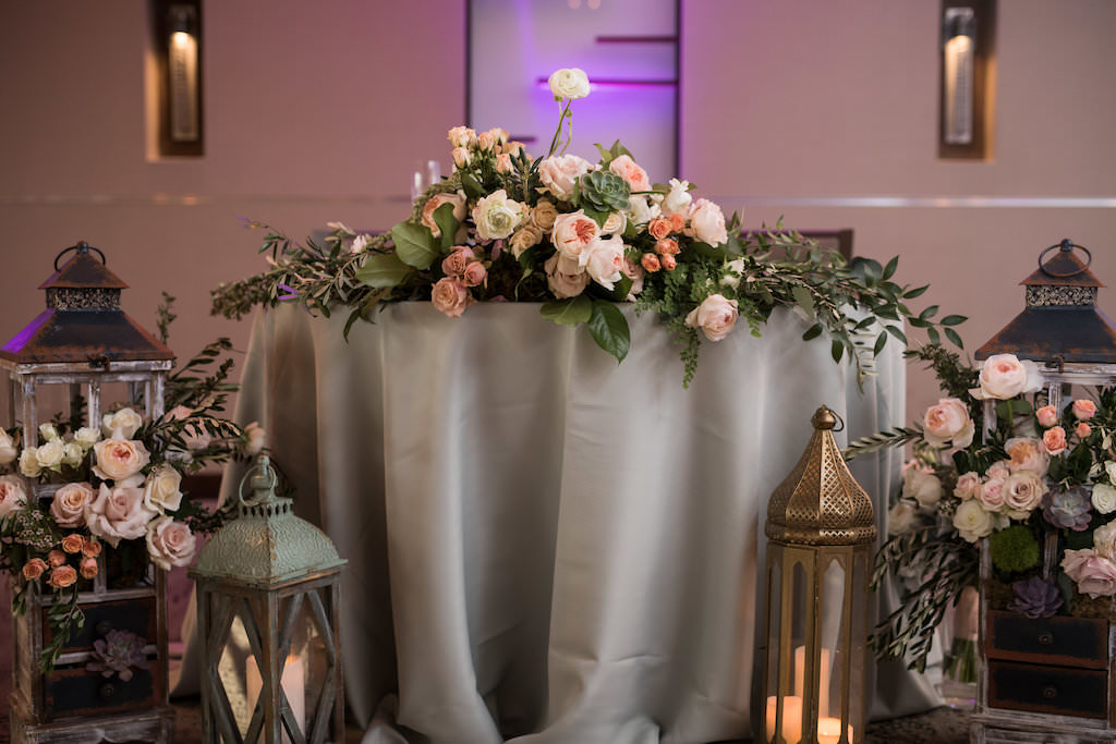 Whimsical Romantic Sarasota Garden Wedding Reception Decor, Sweetheart Table with Silver Linens, Vintage Lanterns with Blush Pink, Ivory, White and Greenery Floral Arrangements and Centerpiece