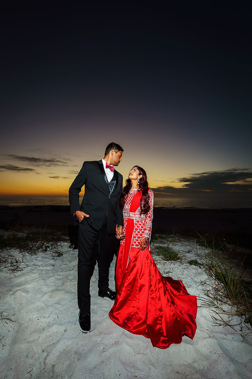 Indian Hindu Bride and Groom Nighttime Beach Wedding Portrait, Bride in Red Silk Sari, Groom in Black Tuxedo | Clearwater Beach Waterfront Wedding Venue Hyatt Regency Clearwater