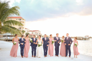Florida Bride, Groom, Bridesmaids in Dusty Rose Mismatched Style Dresses and Groomsmen in Blue Suits with Pink Ties Wedding Party | Photographer LifeLong Photography Studios | St. Pete Beach Waterfront Wedding Venue Isla Del Sol Yacht and Country Club