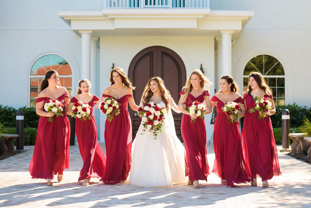 Florida Bride and Bridesmaids Wedding Portrait, Bridesmaids in Matching Off the Shoulder Long Red Dresses with Ivory, Red and Greenery Floral Bouquets | Tampa Hair and Makeup Destiny and Light Hair and Makeup Group | Wedding Dress Truly Forever Bridal