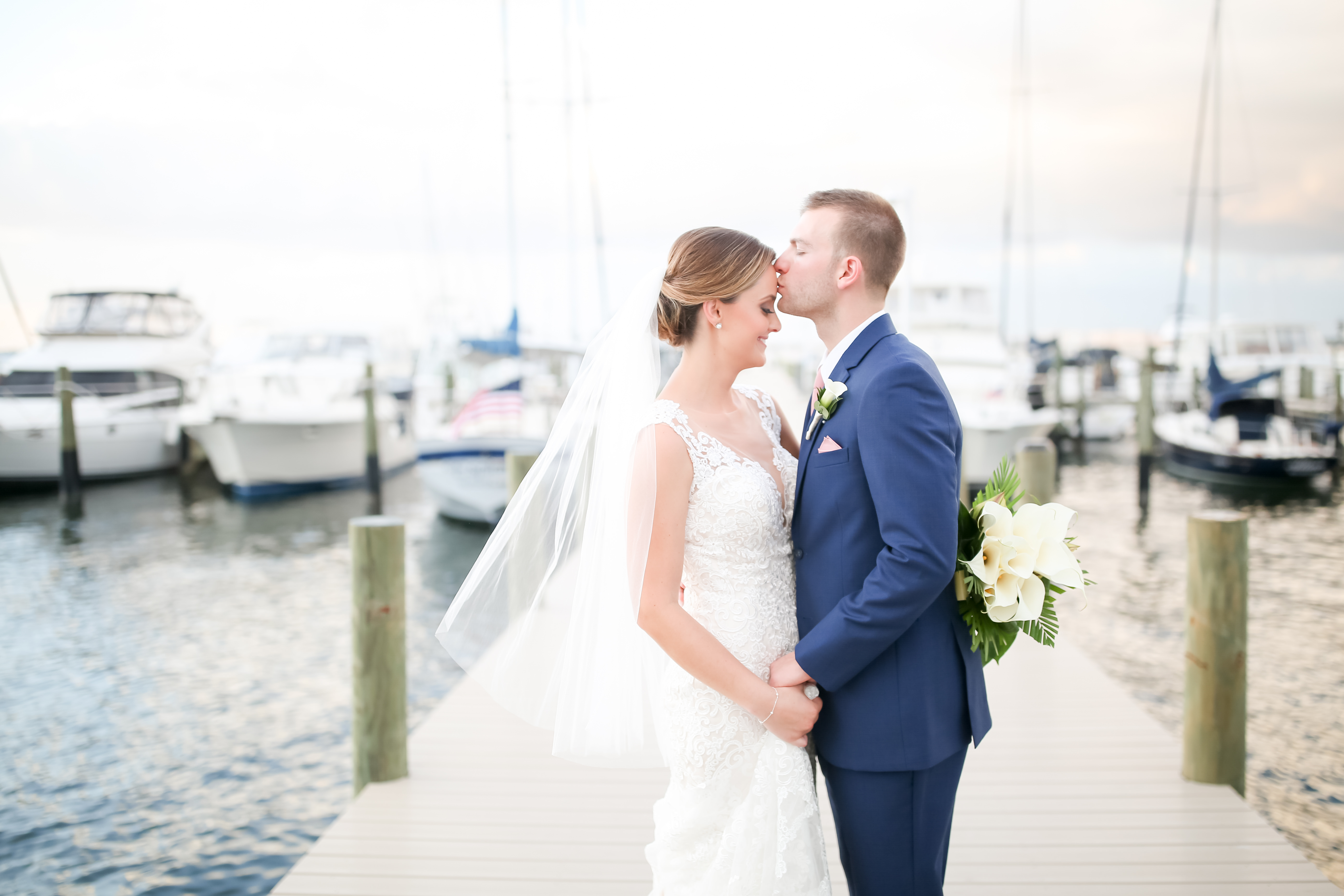 Florida Bride and Groom Sunset Waterfront Yacht Pier Wedding Portrait | Photographer LifeLong Photography Studios | St. Pete Beach Wedding Venue Isla Del Sol Yacht and Country Club | Hair and Makeup Michele Renee The Studio