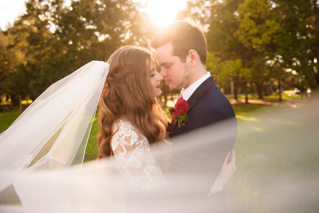 Florida Bride and Groom Sunset Wedding Portrait with Veil Blowing in Wind | Wedding Dress Shop Truly Forever Bridal | Hair and Makeup Destiny and Light Hair and Makeup Group