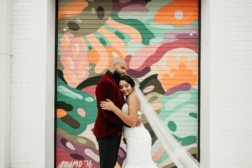 Tampa Bay Bride and Groom Wedding Portrait with Colorful Garage Door and White Brick Wall Backdrop | Lakeland Wedding Venue Haus 820