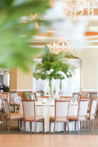 Tropical, Florida Beach Elegant Inspired Ballroom Wedding Reception Decor, Round Tables with Tall Glass Vase, White Florals and Palm Leaf Centerpiece | Photographer LifeLong Photography Studios | St. Pete Beach Waterfront Wedding Venue Isla Del Sol Yacht and Country Club